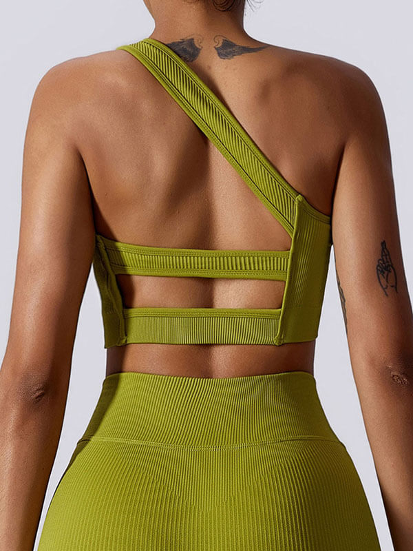 Back view of woman wearing a green one-shoulder sexy sports bra, ideal for fitness and activewear, made from breathable nylon.